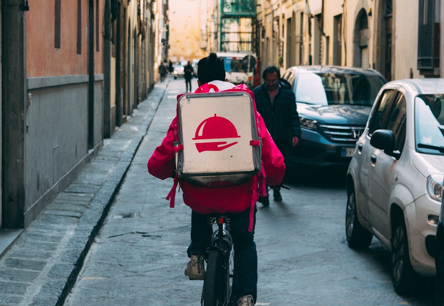 A delivery rider carrying an insulated food bag through the city
