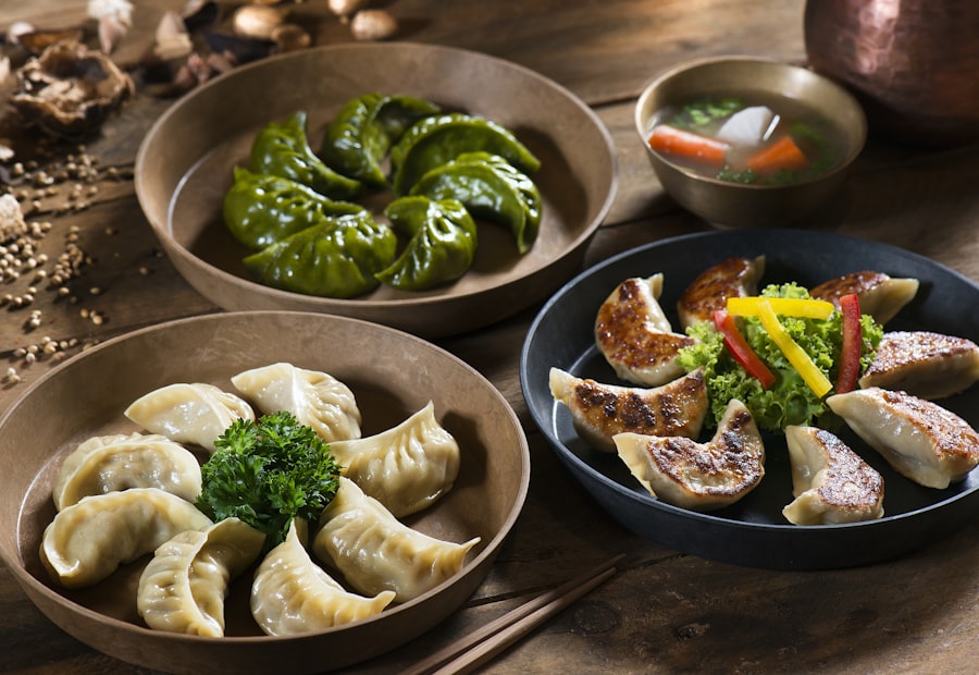 Platters of steamed and pan-fried momos on a wooden table